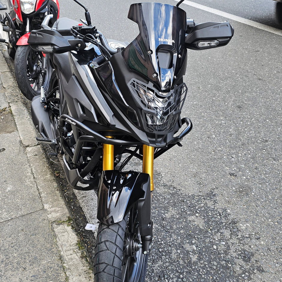 PROTECTOR DE FAROLA EN ACERO HONDA NX 190 - 2.0